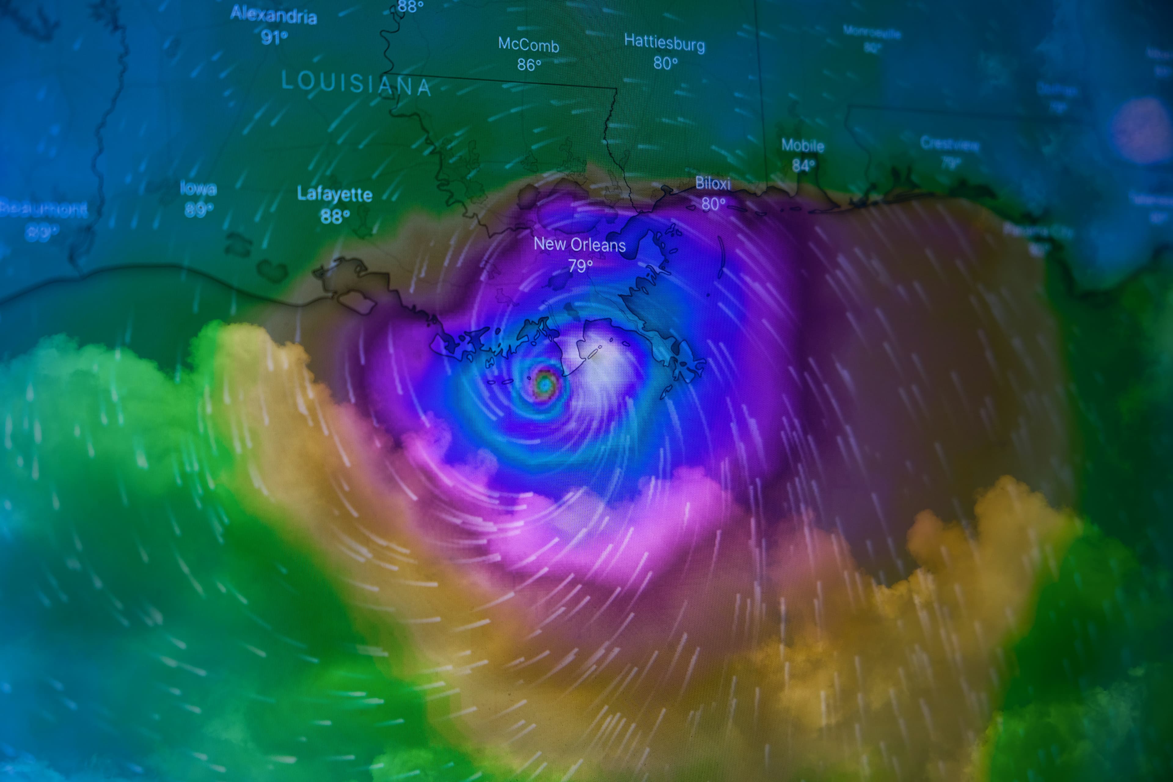 Weather map of a hurricane approaching New Orleans with colored wind speed overlays across the Gulf Coast
